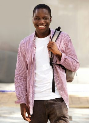 handsome young african student smiling outdoors with bag handsome young african student smiling outdoors with bag